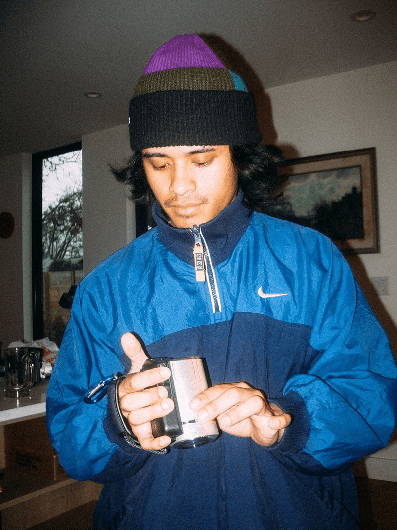 Bonzo in a blue jacket and colorful beanie